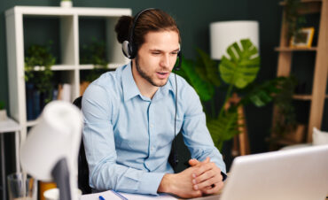 Young man working as customer support in the office
